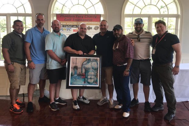 Jake Edwards, second from right, organized a golf tournament to raise funds for the Phantom Fury reunion he organized 15 years after the Second Battle of Fallujah. Also pictured, from left to right: Alex Gonzales, Jack Crandall, Jonathon Allen, Jon-Paul Grizzle, Ryan Cantore, Adel Abudeyah and Pat O'Donnell. (Courtesy of Jake Edwards) Jake Edwards, second from right, organized a golf tournament to raise funds for the Phantom Fury reunion he organized 15 years after the Second Battle of Fallujah. Also pictured, from left to right: Alex Gonzales, Jack Crandall, Jonathon Allen, Jon-Paul Grizzle, Ryan Cantore, Adel Abudeyah and Pat O'Donnell. (Courtesy of Jake Edwards)